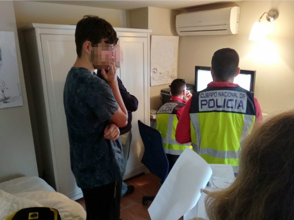 Imagen del menor detenido, con la cara tapada, distribuida por la Policía Nacional cuando han inspeccionado sus ordenadores. FOTO/ POLICÍA NACIONAL