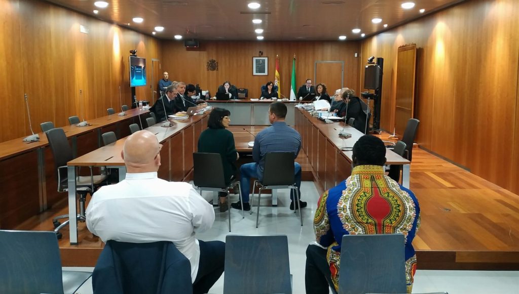Imagen del arranque del juicio este lunes, con dos de los acusados en segundo plano y uno declarando con intérprete. FOTO/ EP